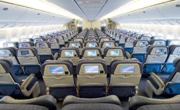 A large airplane with many seats and monitors.